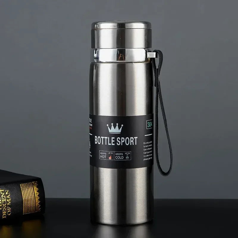 Stainless steel bottle with a label on a dark surface
