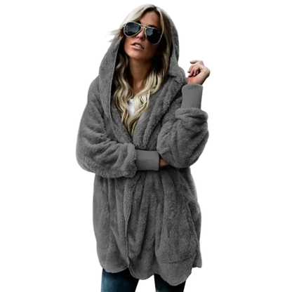 Person wearing a gray hoodie with sunglasses on a white background