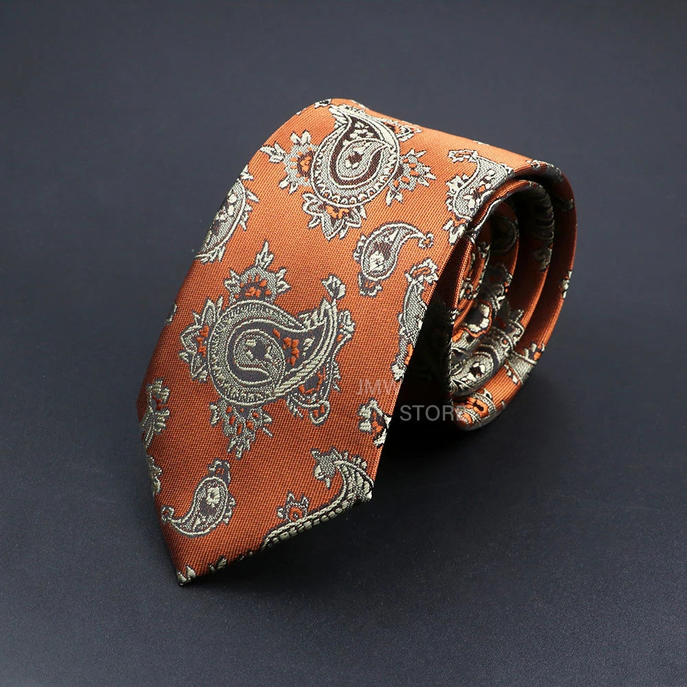 Orange paisley patterned tie on a dark background